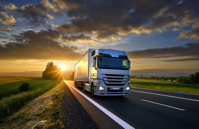 Fleet of commercial trucks on a highway